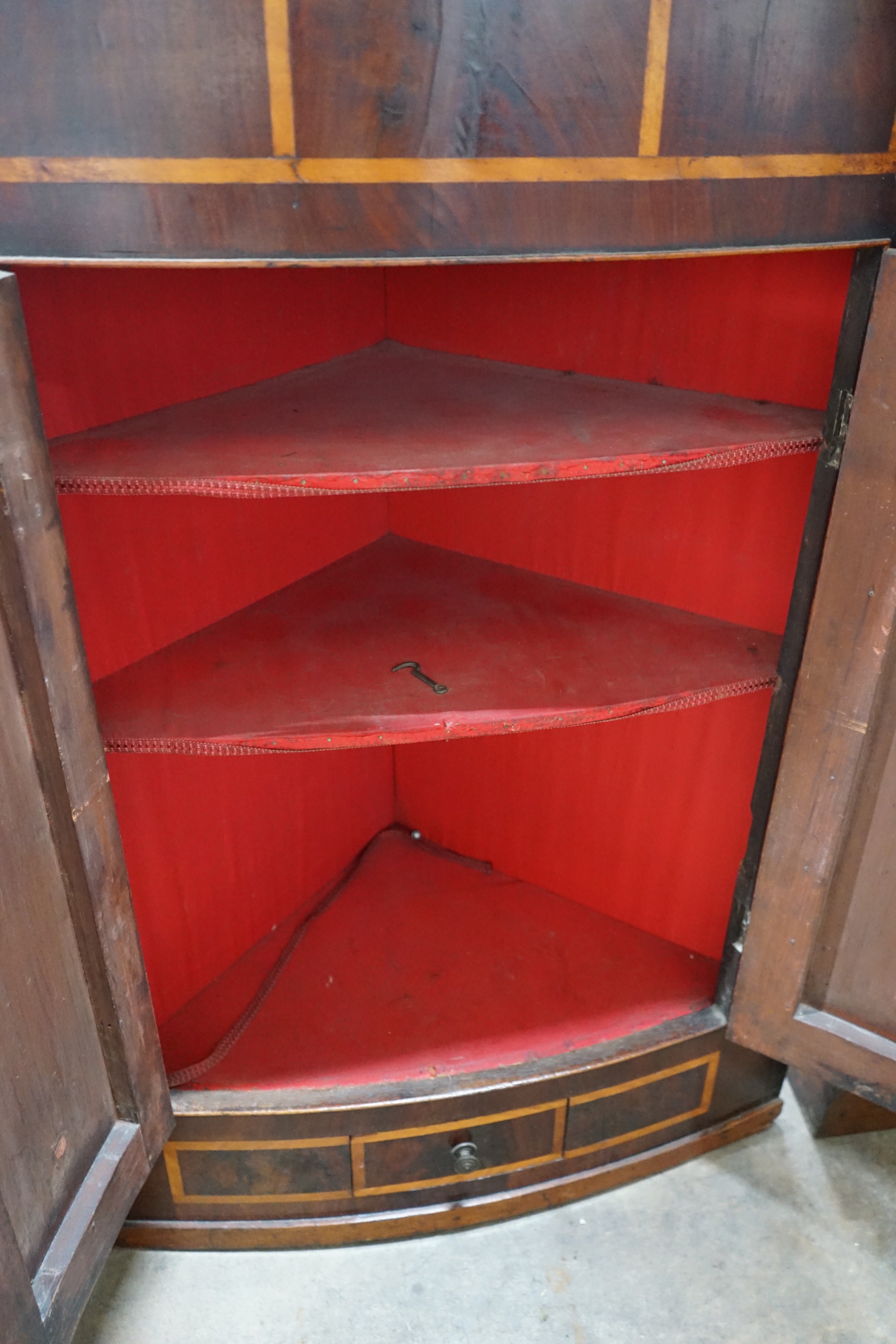 A George III banded mahogany bow front hanging corner cabinet, width 86cm, height 126cm